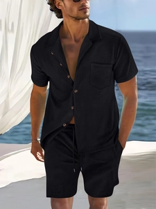Detail of men black waffle knit short sleeve button-down shirt and matching shorts set