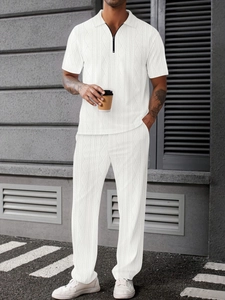 Detail of white men's polo set with textured jacquard stripes and zipper collar