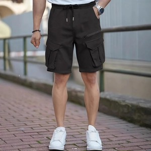 Men's loose cargo shorts in black with elastic drawstring waist and large utility pockets