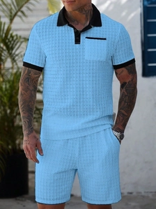 Close-up of sky blue honeycomb knit polo and shorts set with black contrast trim