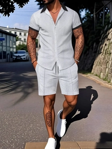 Detail of men's short sleeve set with grey geometric texture and button-up lapel shirt