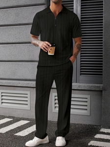 Close-up of black jacquard knit men's polo set with zipper and textured diamond pattern
