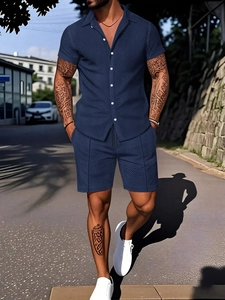 Detail of navy men's short sleeve set featuring geometric texture and button-up shirt
