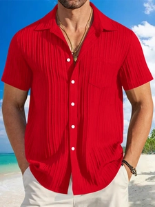 Detail of red striped men's short sleeve linen shirt with chest pocket and white buttons