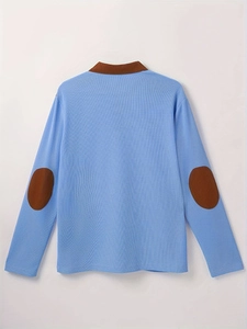 Detailed back view of light blue polo shirt with brown elbow patches and piqué fabric