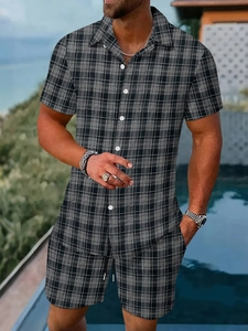 Detail of men's summer plaid two-piece set featuring short sleeves and shorts by a pool