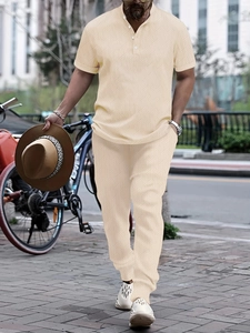 Detail of men's beige two-piece leisure set featuring fine geometric knit textures