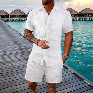 Men's summer beach set featuring white striped short sleeve shirt and shorts in a resort setting