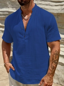 Detail of navy blue men's cotton short sleeve shirt showing texture and henley collar