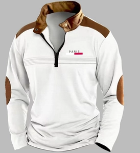 Detail of waffle knit fabric and brown patchwork on white long sleeve polo with zipper