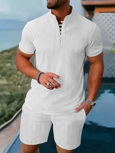 Detail of white rib-knit fabric on men's Henley shirt and shorts set by a pool