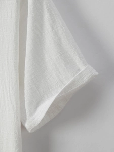 Macro shot of white short sleeve shirt cuff with neat stitching and natural cotton texture