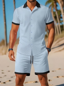 Detail of light blue jacquard shirt with black contrast collar and matching drawstring shorts