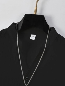 Detail view of cotton shirt collar showing size M label and 100% cotton fabric text