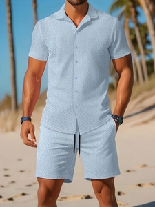 Close-up of light blue jacquard fabric texture on men's summer shirt and shorts set