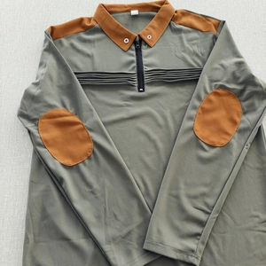 Detail of olive green polo shirt with honeycomb texture and pleated chest detail