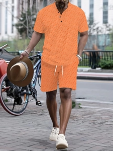 Detail view of men's summer vacation set with orange geometric patterns and casual shorts