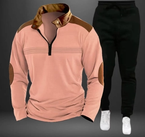 Detail of pink polo shirt zipper with brown contrast panels and matching black joggers