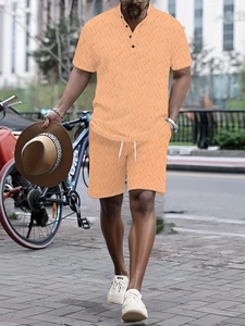 Detail of orange men's summer set with geometric patterns, henley shirt and shorts