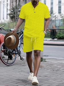 Detail of bright yellow men's polo set with geometric diamond texture and drawstring shorts