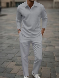 Close-up of light grey waffle texture fabric on men's long sleeve polo and trousers set