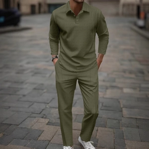 Detailed view of olive green long-sleeve polo set with waffle texture on urban street