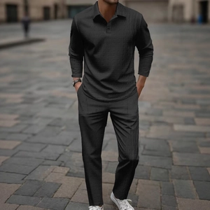 Detail view of men's black leisure set with textured waffle weave long sleeve Polo and pants