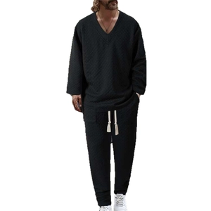 Men's casual black two-piece set featuring textured waffle knit fabric and drawstring waist