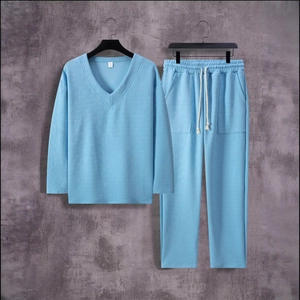Detail of light blue V-neck loungewear set featuring textured waffle knit fabric