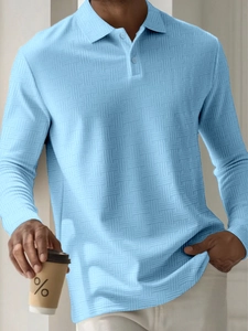 Detail of light blue men's long sleeve polo shirt with textured waffle knit fabric