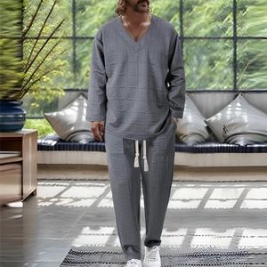 Detail of grey men's two-piece set featuring textured waffle fabric and white drawstring