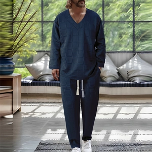 Detail of navy blue textured knit fabric on a men's V-neck lounge set with drawstring