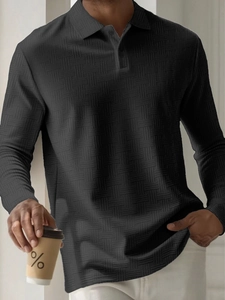 Detail of men's long-sleeve polo shirt featuring premium textured waffle knit fabric