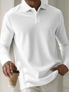 Detailed macro view of men's white long-sleeve polo shirt with waffle textured fabric