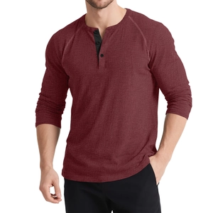 Close-up of wine red waffle knit texture and three-button placket on men's Henley shirt