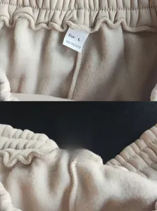 Detail of waist drawstring and 100% polyester wash label on beige fleece sweatpants