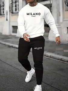 Outdoor shot of white long sleeve sweatshirt and black joggers with Milano print detail