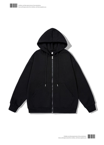 Close-up of black hooded sweatshirt with metal zipper, drawstring, and ribbed cuffs