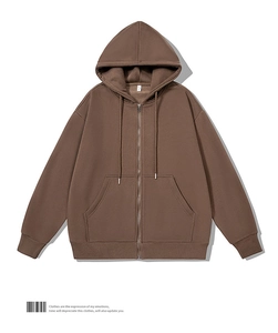 Detail of deep brown zip-up hoodie featuring heavy cotton texture and silver metal zipper