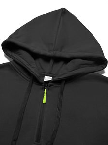 Detail of black hoodie with neon green zipper, drawstring hood and 100% polyester label