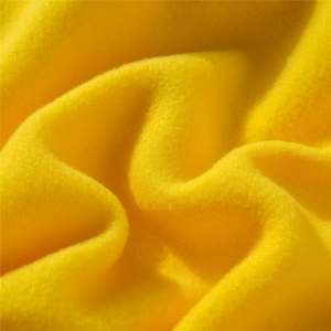 Macro texture detail of vibrant yellow polar fleece fabric for casual anime hoodies