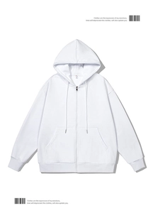 Detail of white zip-up hoodie showing drawstring hood, ribbed cuffs and metal zipper