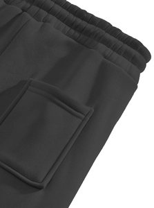 Detail of dark grey fleece jogger pants with elastic waistband and square patch pocket