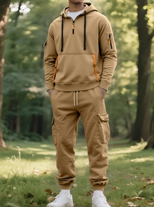 Detail of khaki fleece hoodie and cargo pants set with zip pockets in outdoor forest setting