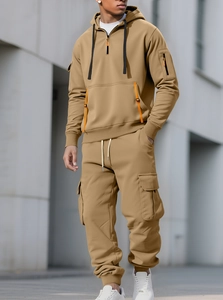 Detailed close-up of khaki fleece hoodie and cargo pants showing zippers and utility pockets