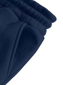Macro shot of navy blue ribbed elastic waistband and side pocket stitching on sports trousers