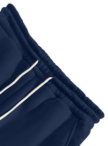 Detailed macro view of navy blue cargo pants featuring elastic waist and beige drawstrings
