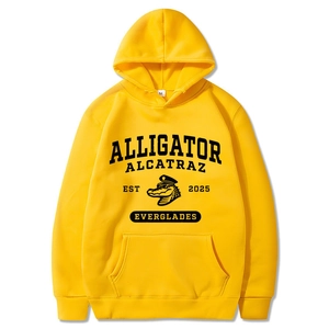 Detail of yellow hoodie featuring Alligator Alcatraz print and front kangaroo pocket