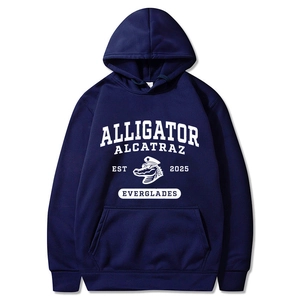 Detail of the white alligator graphic and varsity text on the navy blue hoodie