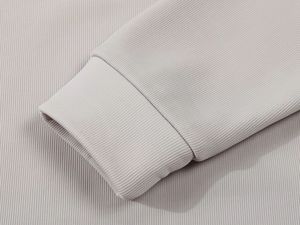 Close-up of ribbed knit cuffs on light grey half-zip polo sweatshirt for men